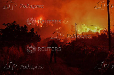 Wildfire burns next to the village of Ano Loutro, near Corinth