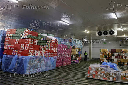 Workers handle boxes of flowers for export before Valentine?s Day, in Quito