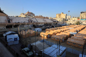 Displaced Palestinians take shelter in a tent camp set up at Palestine Stadium, which was damaged during the Israeli offensive, in Gaza City