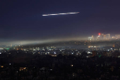 A Lebanese Middle East Airlines (MEA) aircraft flies over Beirut's southern suburbs