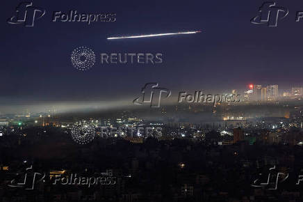 A Lebanese Middle East Airlines (MEA) aircraft flies over Beirut's southern suburbs