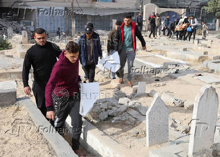 Mourners carry bodies of Palestinians killed in an Israeli airstrike, at Nuseirat refugee camp