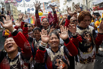 Filipino Catholics participate in the parade of Black Nazarene replicas