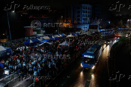 Pro-Yoon protesters are seen in the early light after rallying throughout the night in support of impeached South Korean President Yoon Suk Yeol near his official residence, in Seoul