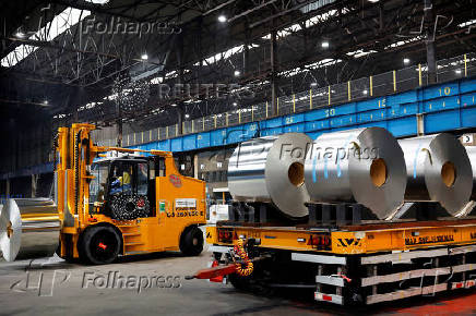 A worker moves rolls of steel at the Tata Steel factory in Velsen-Noord