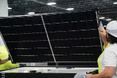 FILE PHOTO: Employees work on solar panels at the QCells solar manufacturing factory in Dalton