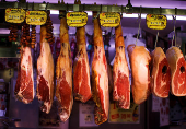 FILE PHOTO: Spanish Iberico and Serrano hams are seen hanging at the Anton Martin market in Madrid