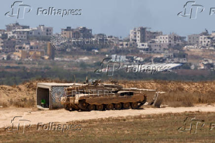 An Israeli tank stands in position near the Israel-Gaza border