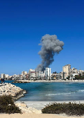 Smoke billows after an Israeli strike, amid the ongoing hostilities between Hezbollah and Israeli forces, in Tyre