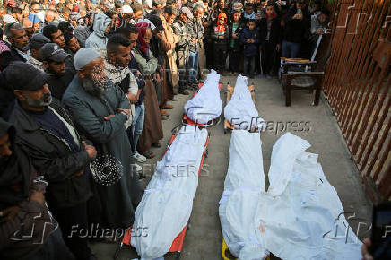 Palestinians mourn loved ones killed in Israeli strikes, in Khan Younis in the southern Gaza Strip