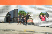 People watch motorcade of U.S. President Joe Biden in Luanda