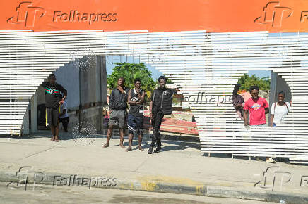 People watch motorcade of U.S. President Joe Biden in Luanda