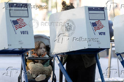 FILE PHOTO: Voters cast their ballot at a polling station during early voting in New York City