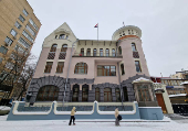 People walk past the Syrian embassy in Moscow