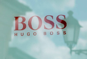 FILE PHOTO: Hugo Boss store logo is seen on a shopping center at the outlet village Belaya Dacha outside Moscow