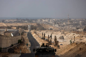 An Israeli military vehicle drives through the Philadelphi Corridor area in southern Gaza