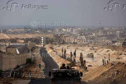 An Israeli military vehicle drives through the Philadelphi Corridor area in southern Gaza