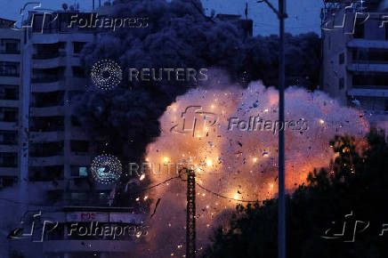 Smoke and flame rise after an Israeli strike, in the Chiyah district of Beirut's southern suburbs