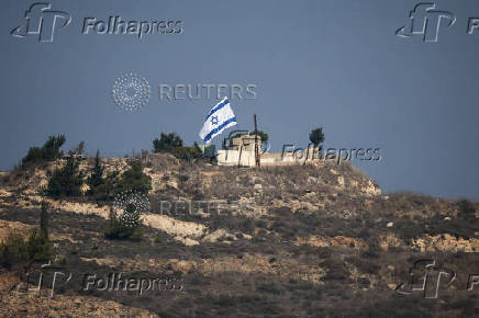 An Israeli flag flies in southern Lebanon, near the Israel-Lebanon border