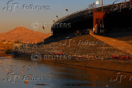 Razor wire fence to inhibit the crossing of migrants into the United States is seen along the bank of the Rio Bravo River, as seen from Ciudad Juarez