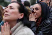 People gather ahead of the expected release of Israeli hostages, in Tel Aviv