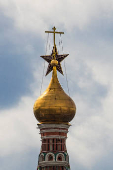 A star atop of the Spasskaya tower of the Kremlin is seen next to the dome of St. Basil's Cathedral in Moscow