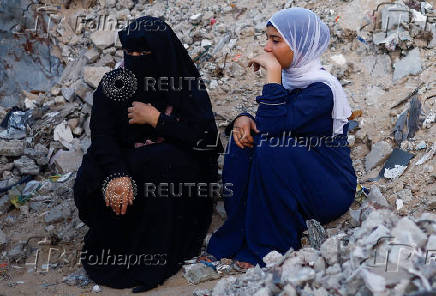 Palestinians hold Eid al-Adha prayers by the ruins of the Al-Rahma mosque destroyed by Israeli air strikes, in Khan Younis, in the southern Gaza strip