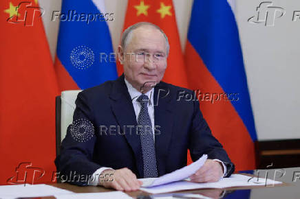 Russian President Vladimir Putin holds a video conference meeting with Chinese President Xi Jinping, outside Moscow