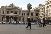 People walk along a street, in Damascus