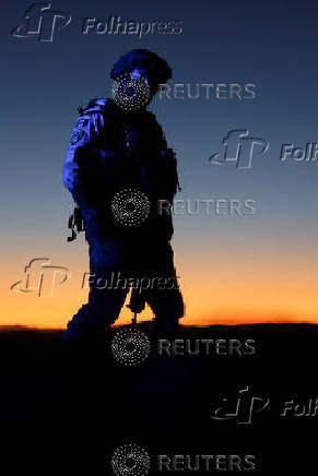 A member of Mexico's National Guard patrols near the scene where an agent of the National Institute of Migration (INM) is suspected to have been killed, on the outskirts of Ciudad Juarez