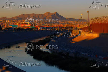 Razor wire fence to inhibit the crossing of migrants into the United States is seen along the bank of the Rio Bravo River, as seen from Ciudad Juarez