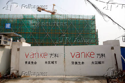 FILE PHOTO: FILE PHOTO: The logo of property developer China Vanke is seen on gates at a construction site in Shanghai