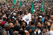 Mourners carry the body of a Palestinian who was killed during an Israeli settlers' attack on Aqraba