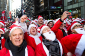 Revellers take part in SantaCon in New York City