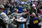 Members of the Bolivarian Militia and supporters of President Nicolas Maduro march to plead allegiance