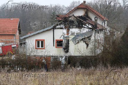 Emergency personnel work at a damaged nursing home that caught fire, outside Belgrade