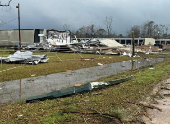 Debris from a damaged structure lies on the ground in an area afected by the weather, in Montgomery County, Texas