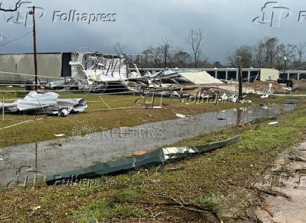 Debris from a damaged structure lies on the ground in an area afected by the weather, in Montgomery County, Texas