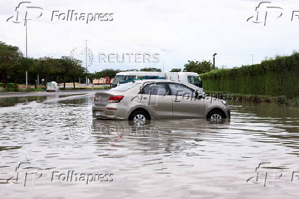 Parked cars stand in flood water following heavy rains in Dubai