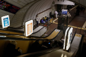People take shelter inside a metro station during a Russian missile strike in Kyiv