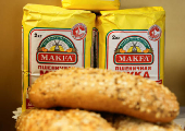 Packs of Makfa flour are seen next to loaves of bread in a showcase of a supermarket in Moscow