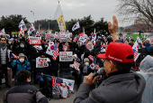 Pro-Yoon supporters take part in a rally outside the Seoul Detention Center in Uiwang