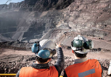 Two men stand at Anglo American's El Soldado copper mine in Chile