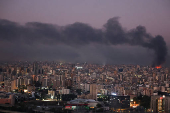 Smoke billows over Beirut's southern suburbs, as seen from Sin El Fil