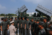 Members of the Taiwanese navy Hai Feng (Sea Blade) Group listen to a briefing in front of Hsiung Feng III and II mobile missile launchers after Taiwanese President Lai Ching-te?s visit to the base in response to recent Chinese military drills, in Taoyuan