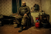 A serviceman rests at his positions near a frontline near the town of Chasiv Yar