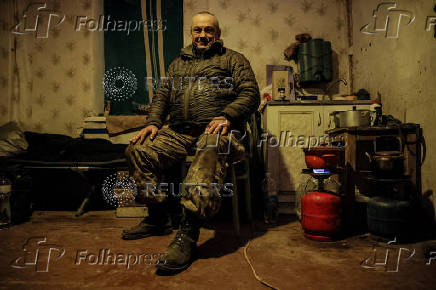 A serviceman rests at his positions near a frontline near the town of Chasiv Yar