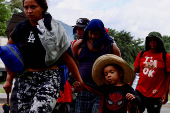 Migrants walk in a caravan in an attempt to reach the U.S. border, in Huixtla