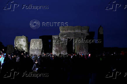 Revellers attend winter solstice celebrations at Stonehenge stone circle near Amesbury