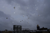 Pigeons fly during the city's first snowfall of the season, on the first day of winter in the Queens borough of New York City